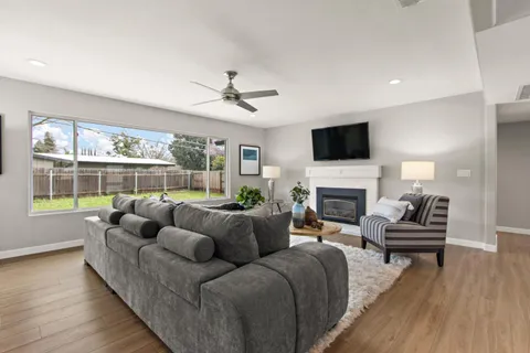 a living room with furniture a fireplace and a flat screen tv