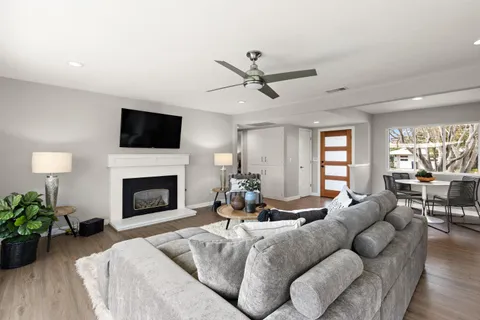 a living room with furniture a fireplace and a flat screen tv