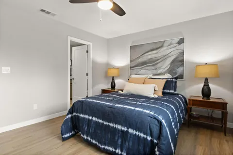 a bedroom with a bed and wooden floor