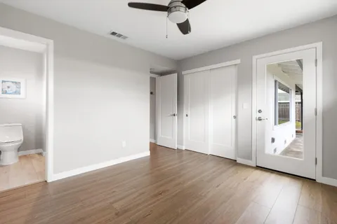 a view of an empty room and wooden floor