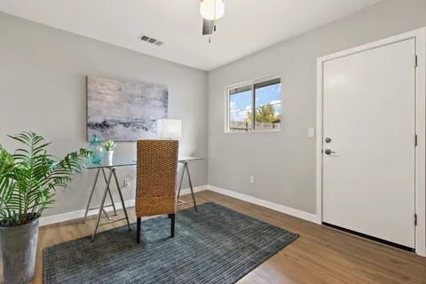 a view of a livingroom with furniture and a potted plant