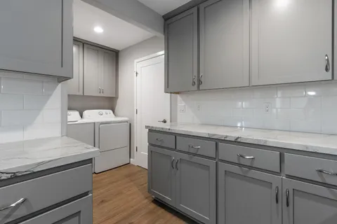 a view of a kitchen with sink and cabinets