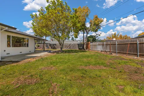a swimming pool with outdoor seating and yard