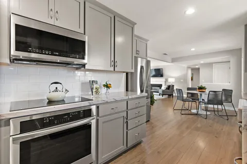 a kitchen with stainless steel appliances a stove a sink and a microwave