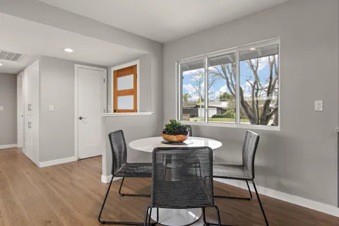 a dining room with furniture wooden floor and a rug