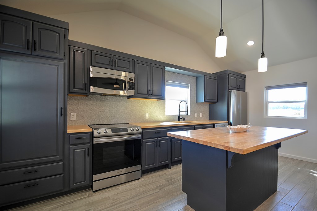 110 A Garner Road Kerrville, TX 78028 - Photo 12 of 46 a kitchen with stainless steel appliances granite countertop a sink stove and refrigerator