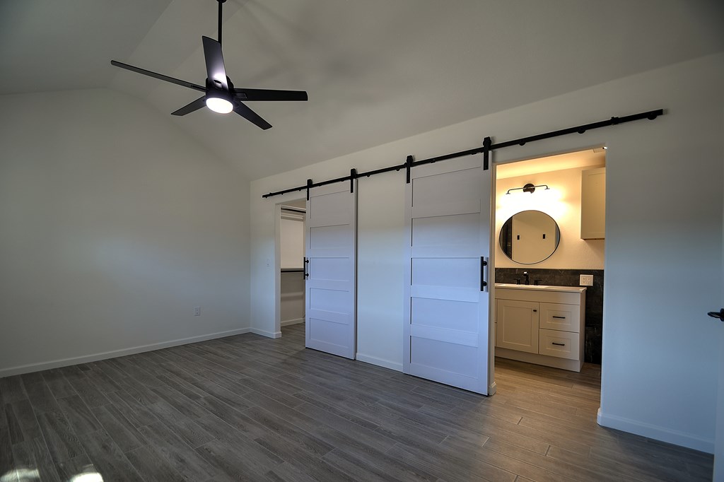 110 A Garner Road Kerrville, TX 78028 - Photo 14 of 46 a view of a room with wooden floor cabinet and a ceiling fan