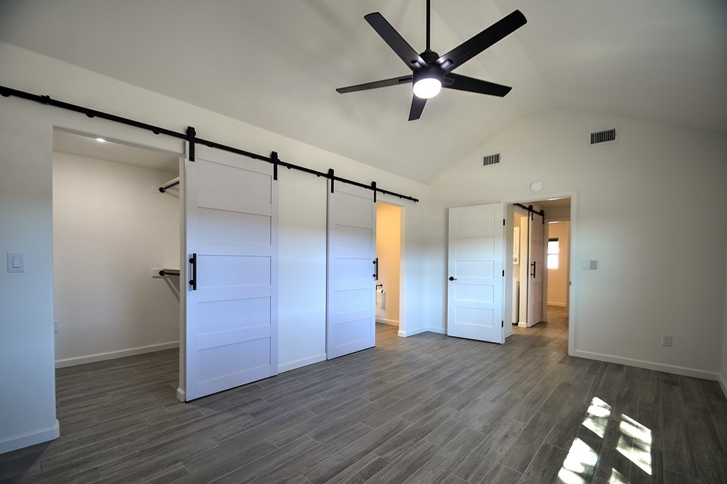 110 A Garner Road Kerrville, TX 78028 - Photo 15 of 46 an empty room with wooden floor and a ceiling fan