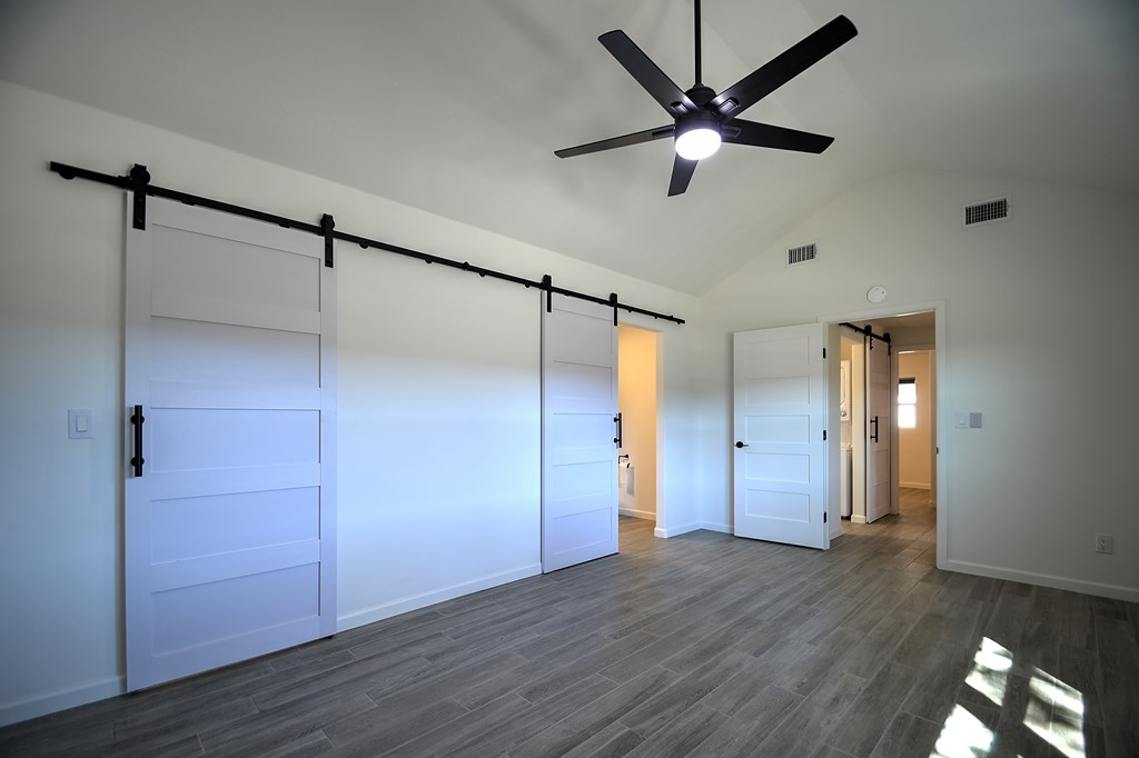 110 A Garner Road Kerrville, TX 78028 - Photo 16 of 46 a view of an empty room with wooden floor