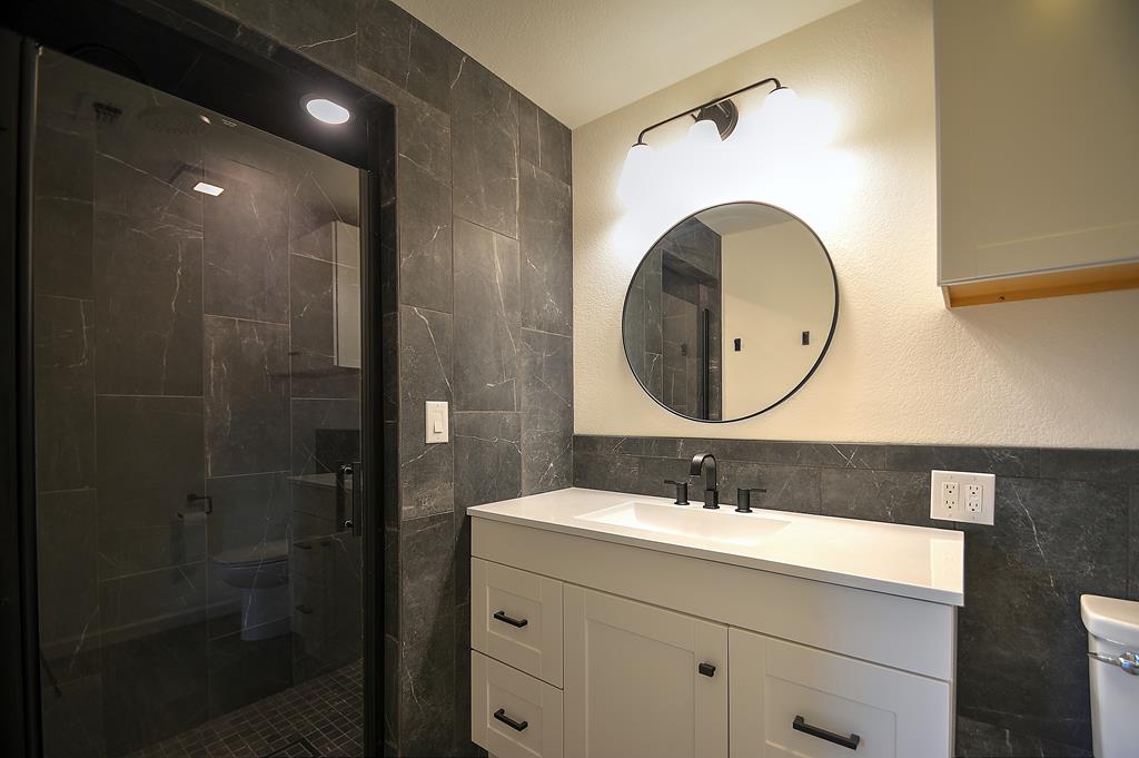 110 A Garner Road Kerrville, TX 78028 - Photo 19 of 46 a bathroom with a sink mirror and shower