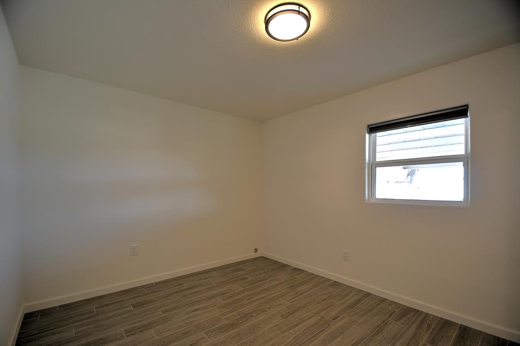 110 A Garner Road Kerrville, TX 78028 - Photo 21 of 46 an empty room with wooden floor and windows