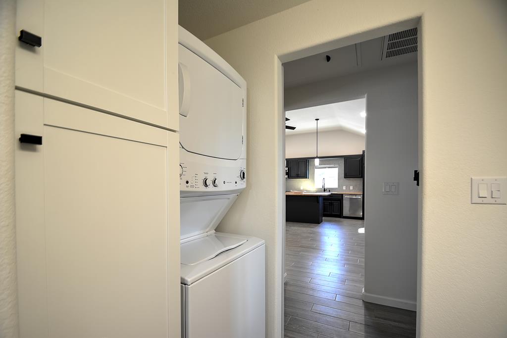 110 A Garner Road Kerrville, TX 78028 - Photo 27 of 46 a view of a hallway that has a couch and a stove with wooden floor