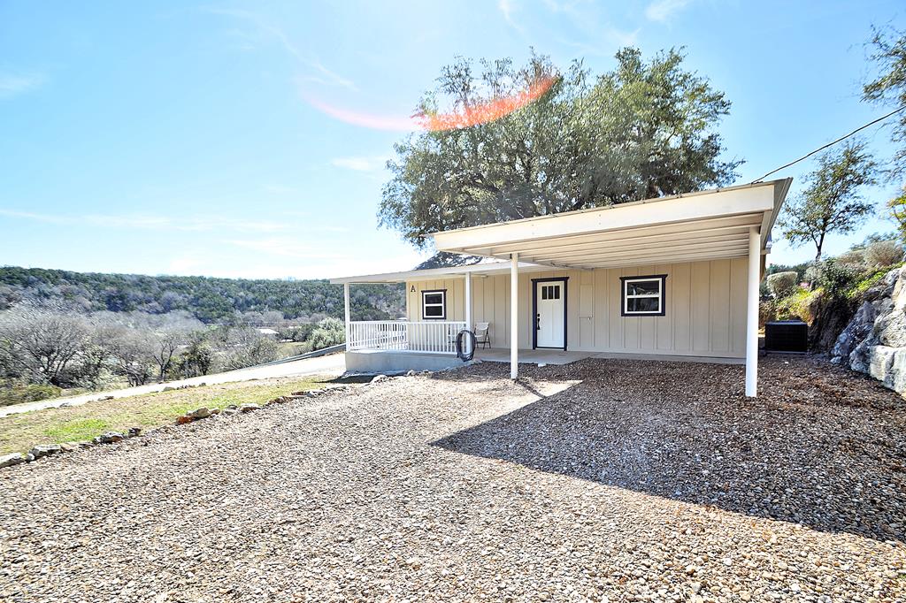 110 A Garner Road Kerrville, TX 78028 - Photo 30 of 46 a front view of a house with a yard and potted plants