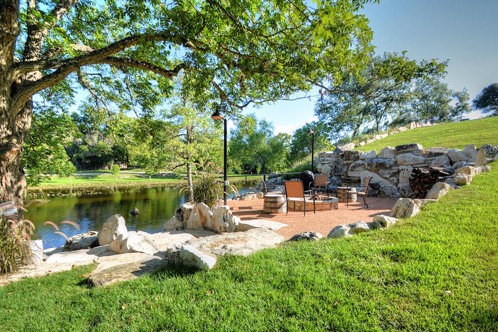 110 A Garner Road Kerrville, TX 78028 - Photo 41 of 46 a view of a lake with a bench and trees around