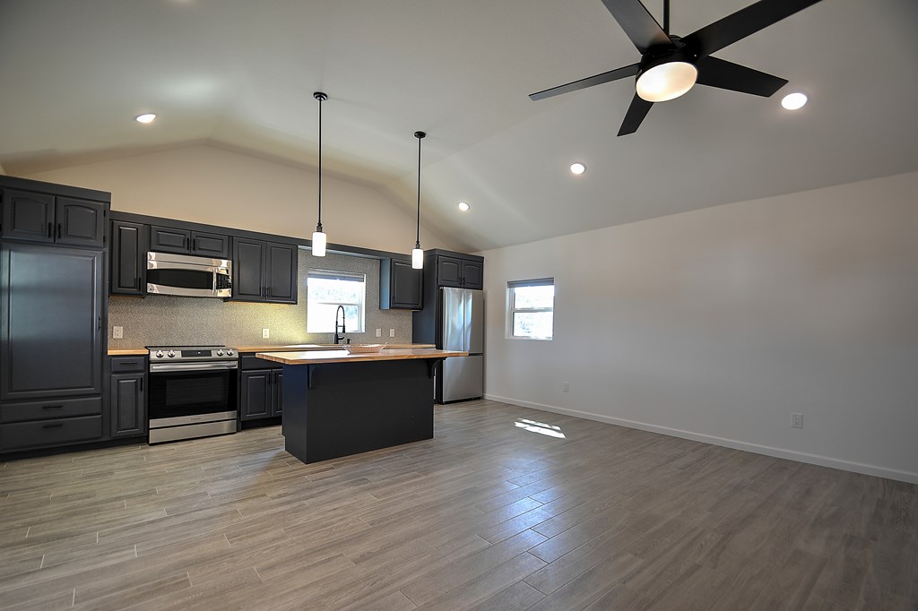 110 A Garner Road Kerrville, TX 78028 - Photo 5 of 46 a large kitchen with stainless steel appliances kitchen island a large island in the center
