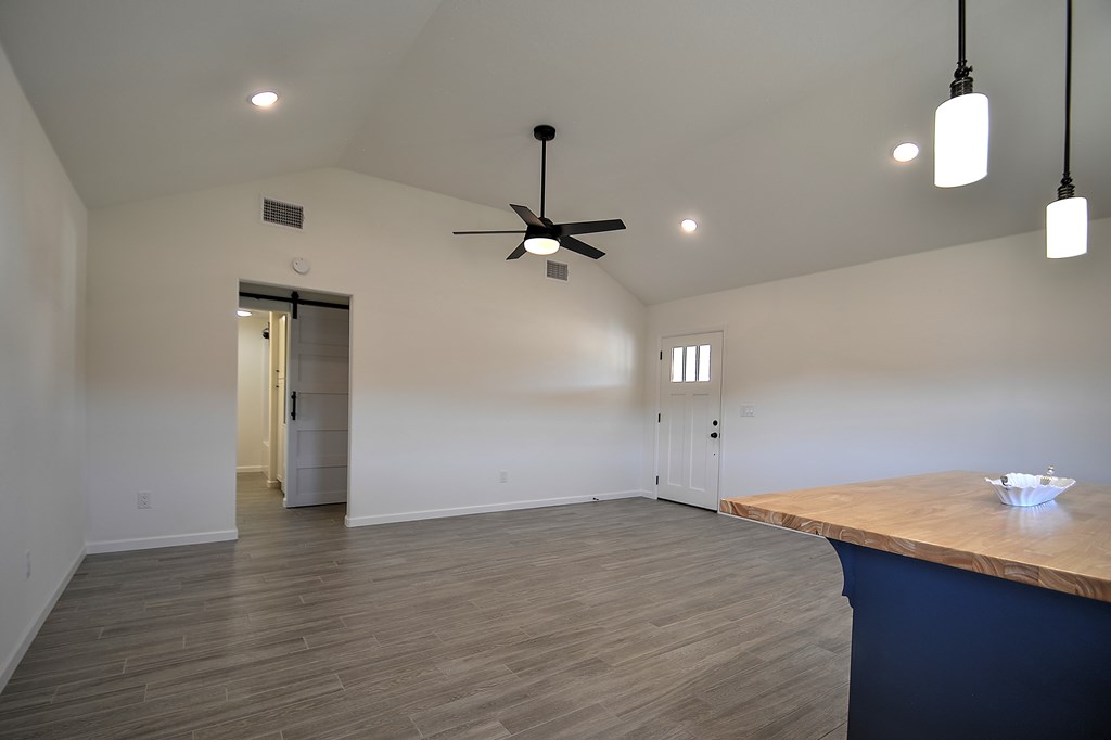 110 A Garner Road Kerrville, TX 78028 - Photo 7 of 46 a view of an empty room with wooden floor and a ceiling fan