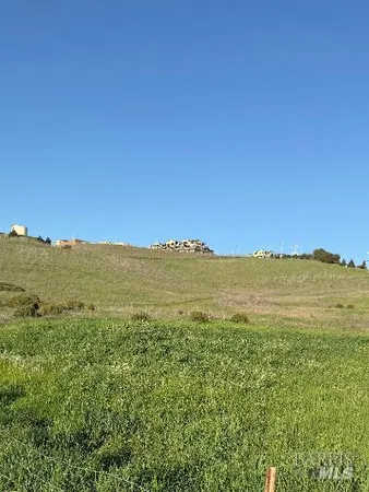 a view of a mountain range with lush green forest