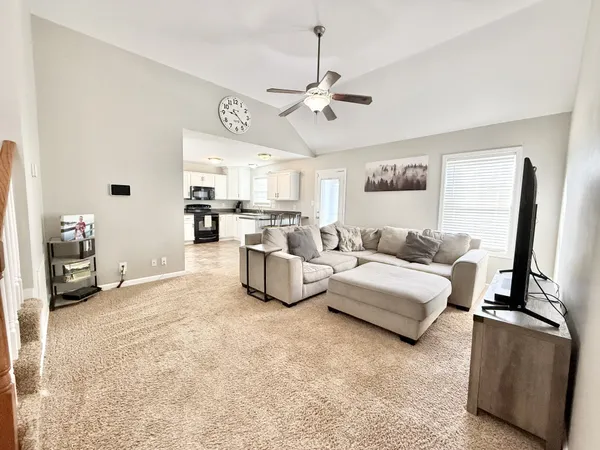 a living room with furniture and a flat screen tv
