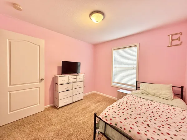 a bedroom with a bed and a television