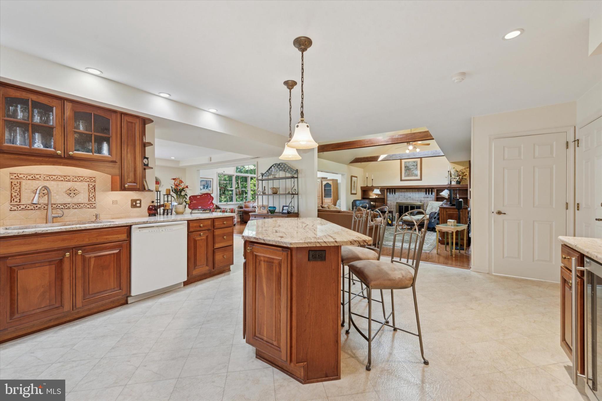 856 Monteith Drive Wayne, PA 19087 - Photo 13 of 35 a kitchen that has a lot of cabinets in it and wooden floors
