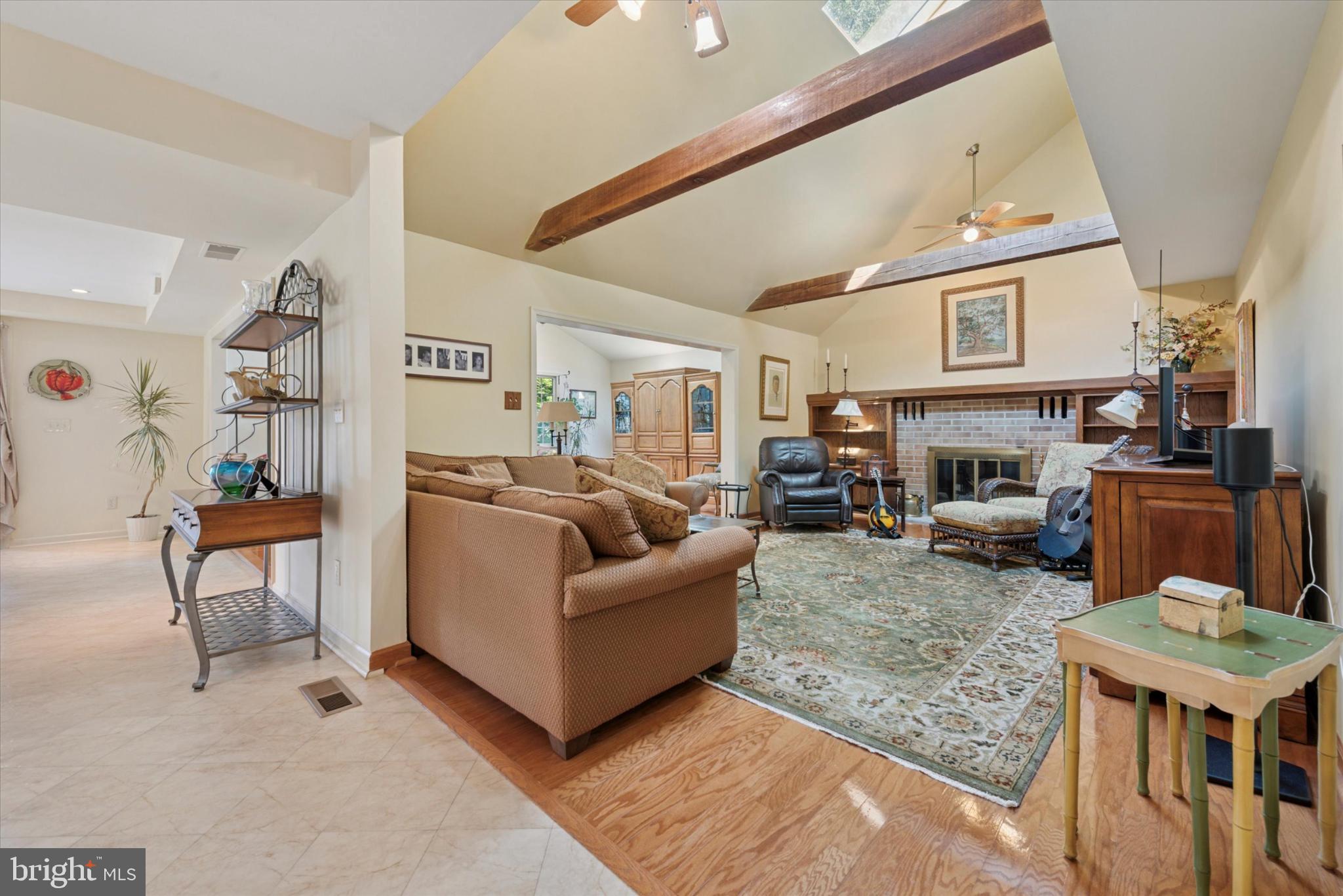 856 Monteith Drive Wayne, PA 19087 - Photo 19 of 35 a living room with furniture a fireplace and a flat screen tv