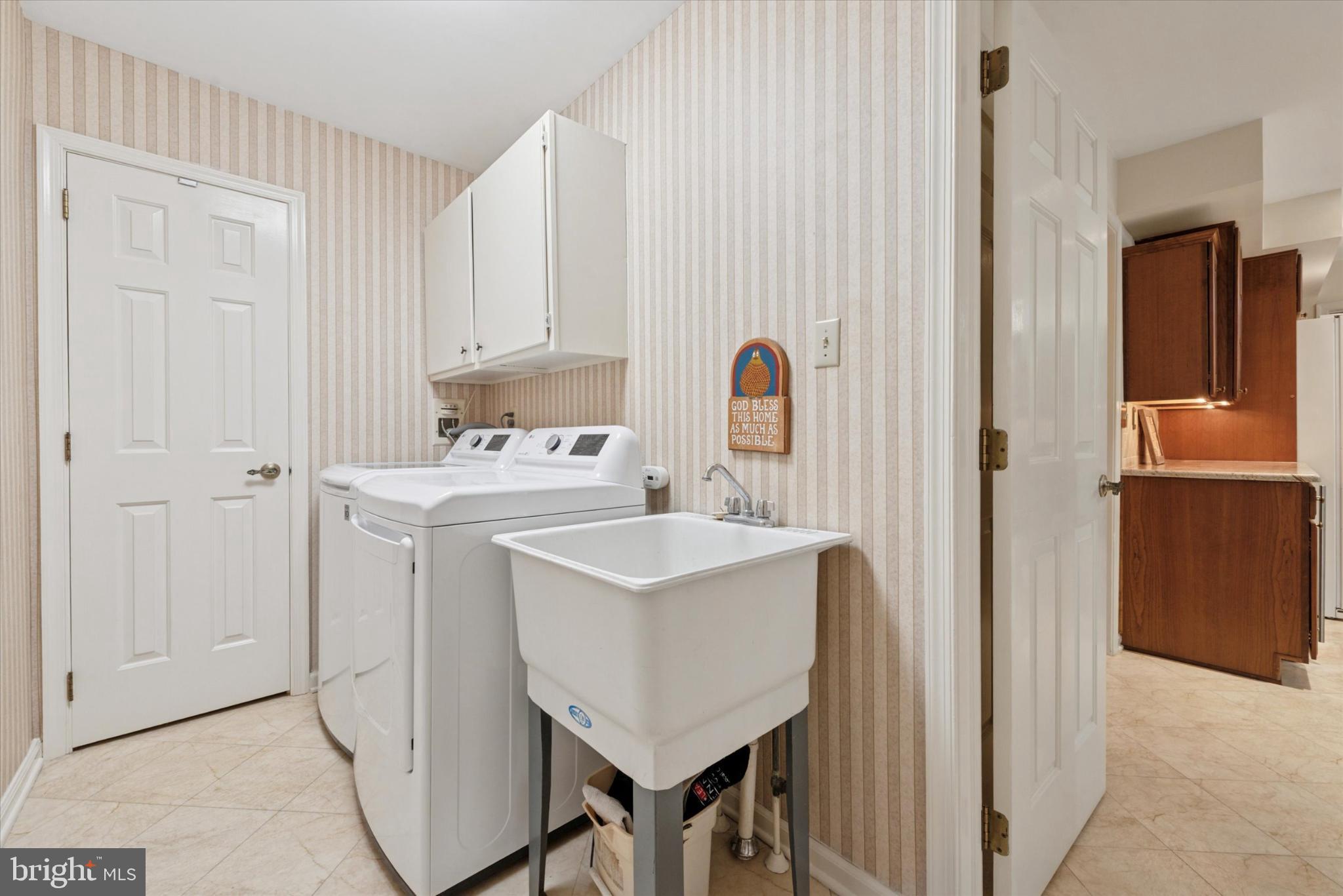856 Monteith Drive Wayne, PA 19087 - Photo 25 of 35 a utility room with cabinets washer and dryer