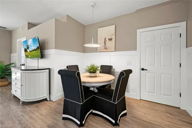 a view of a dining room with furniture and wooden floor