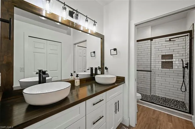 a bathroom with a double vanity sink and mirror
