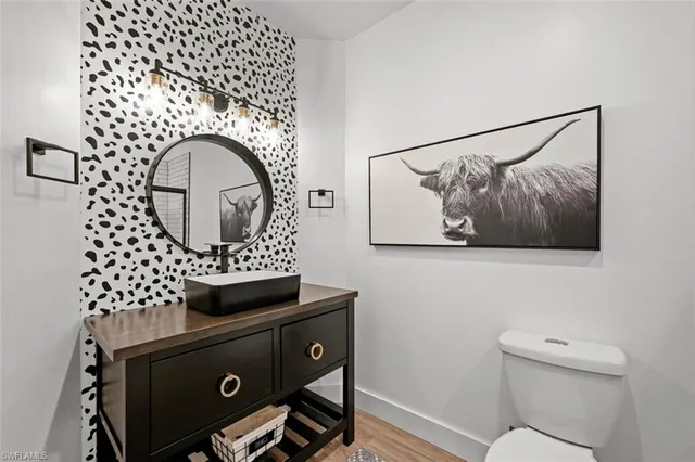 a bathroom with a toilet a sink and mirror