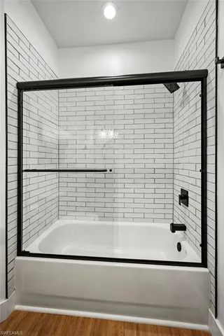 a bathroom with a bathtub and a shower