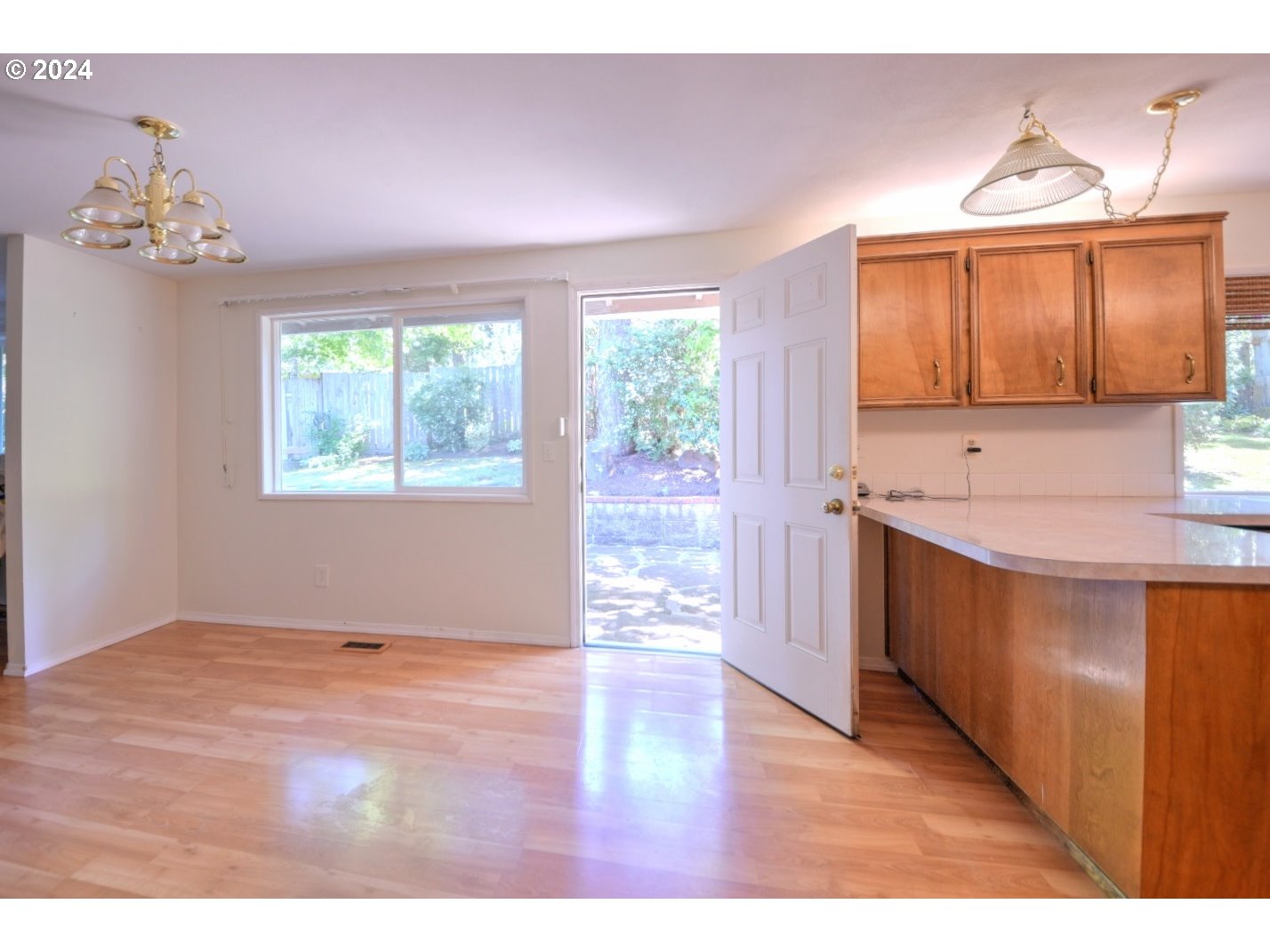 443 South 68th Place Springfield, OR 97478 - Photo 6 of 32 a kitchen with kitchen island granite countertop a sink window and cabinets