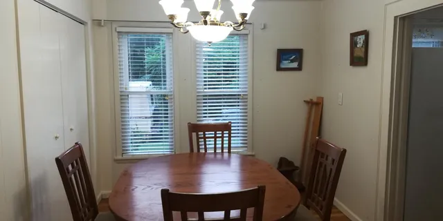 a view of a dining room with furniture and a window