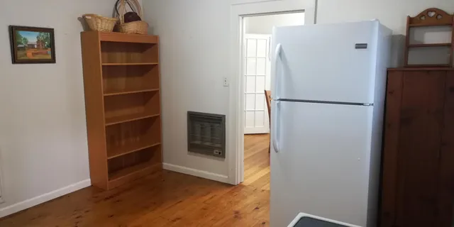 a white refrigerator freezer and a stove sitting inside of a kitchen