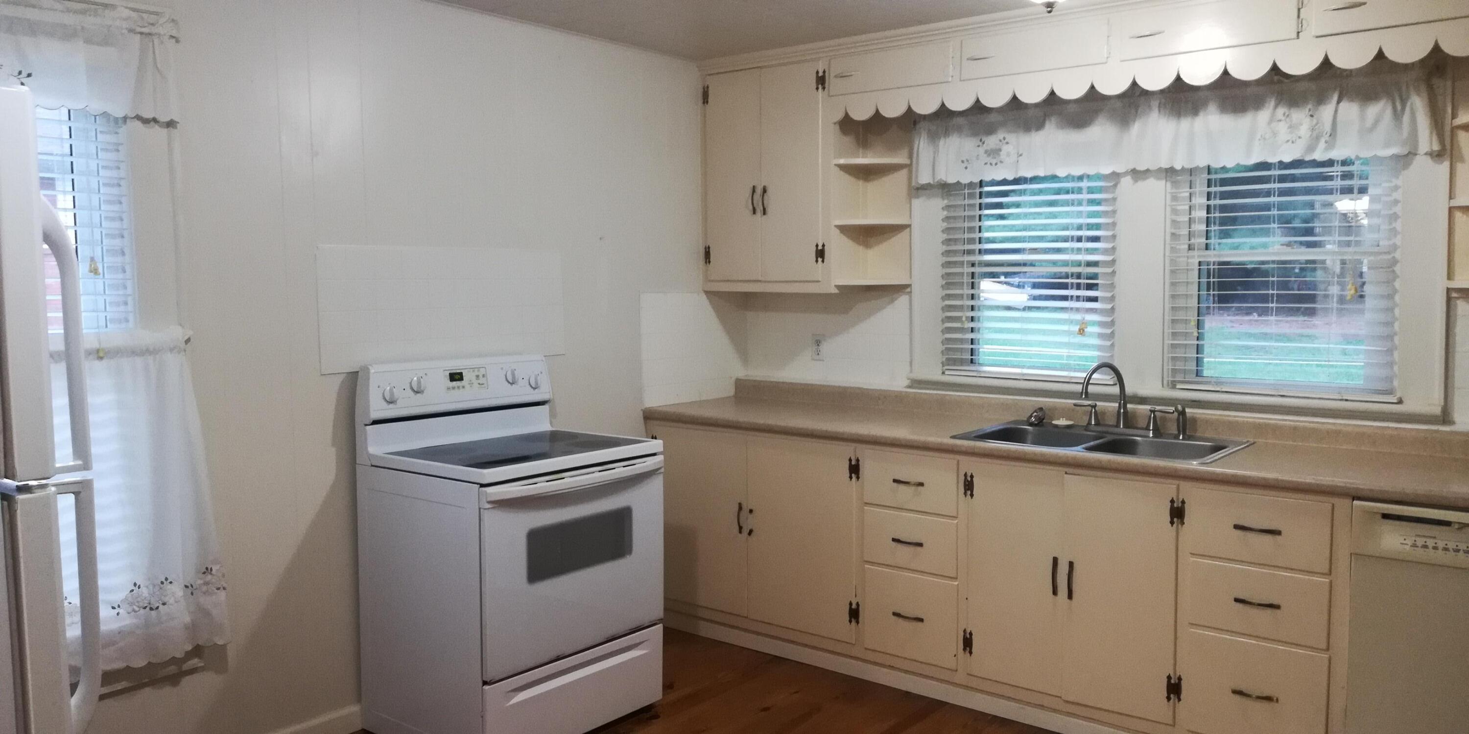 62 Campbell Creek Road Maggie Valley, NC 28751 - Photo 9 of 15 a kitchen with granite countertop white cabinets and white appliances