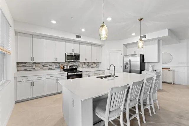 a living room with furniture a chandelier and a dining room