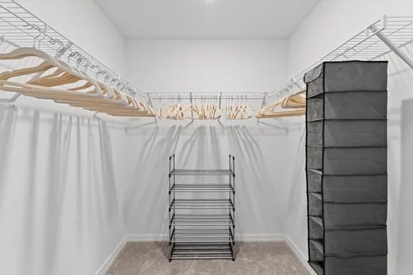 a bedroom with a bed and a ceiling fan