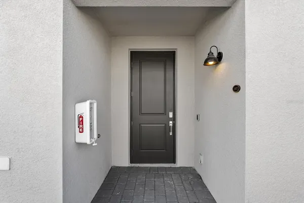 a kitchen with white cabinets and refrigerator