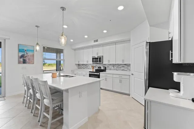 a kitchen with sink stove and microwave