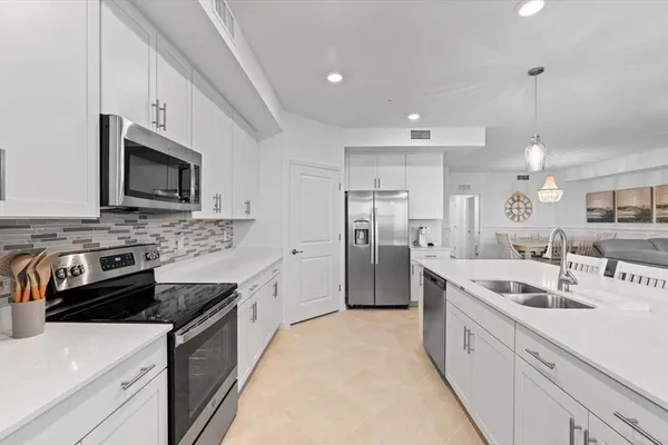 a kitchen with stainless steel appliances kitchen island granite countertop a sink and cabinets