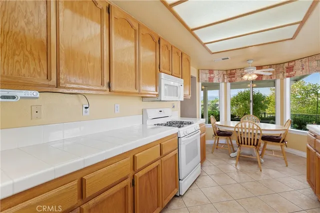 a kitchen with a sink and chairs