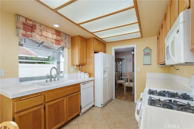 a kitchen with stainless steel appliances granite countertop a sink and cabinets