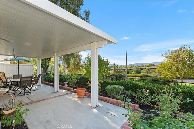 a view of a patio with table and chairs and potted plants