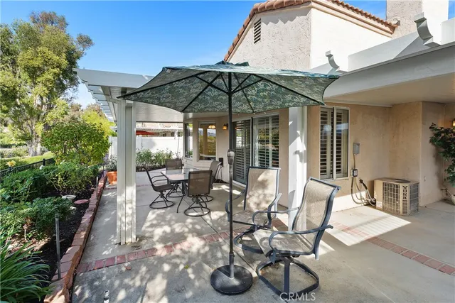 a view of a patio with a table and chairs