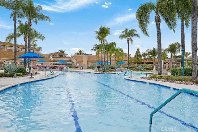 a view of a swimming pool and lounge chairs