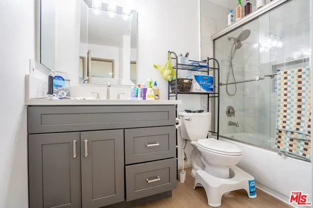 a bathroom with a sink toilet a mirror and shower