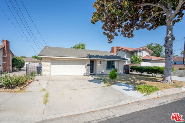 a front view of a house with a yard and outdoor seating
