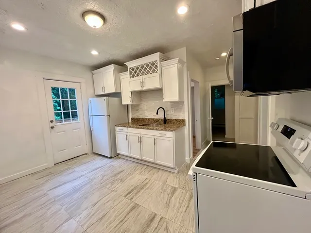 a kitchen with a refrigerator and a sink