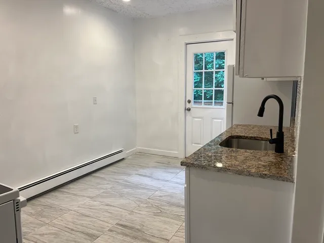 a kitchen with a refrigerator and a window