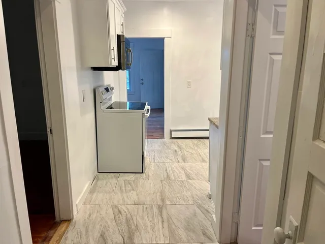 a room with a stove and a refrigerator