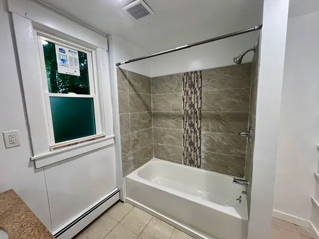 a bathroom with a bathtub and a shower